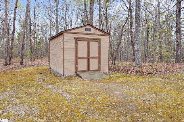 view of shed featuring a wooded view