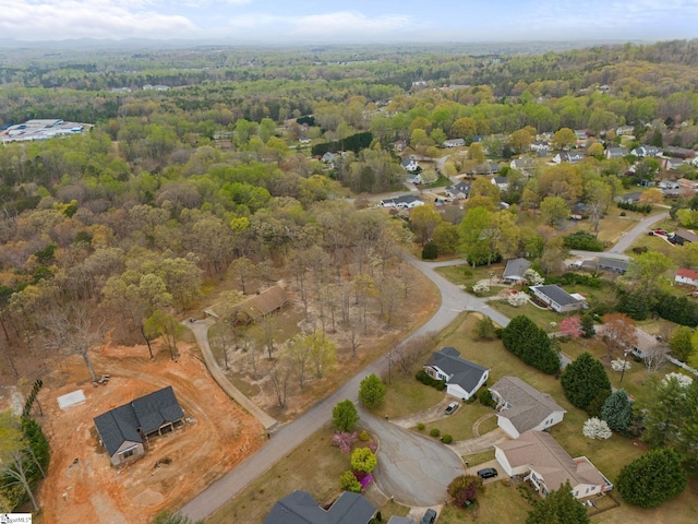 birds eye view of property featuring a wooded view