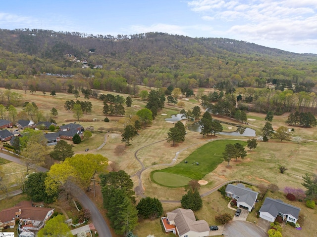 aerial view featuring a water view, a wooded view, and view of golf course