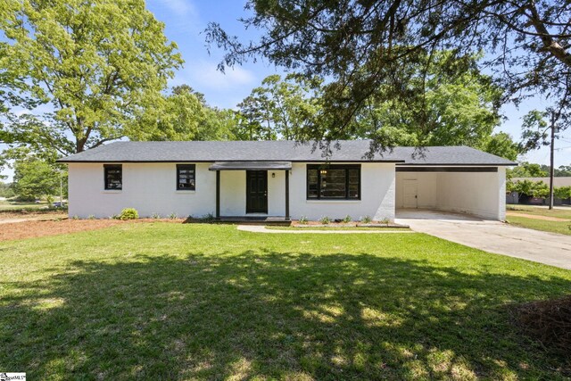 single story home with driveway, a front lawn, and a carport