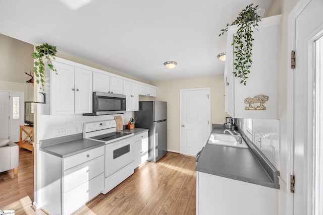 112 Jocassee Falls Rd, Salem, SC 29676 - kitchen with a sink, light wood-type flooring, dark countertops, white cabinetry, and appliances with stainless steel finishes
