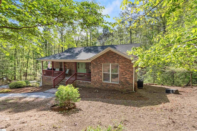 112 Jocassee Falls Rd, Salem, SC 29676 - ranch-style house featuring brick siding, cooling unit, roof with shingles, and covered porch