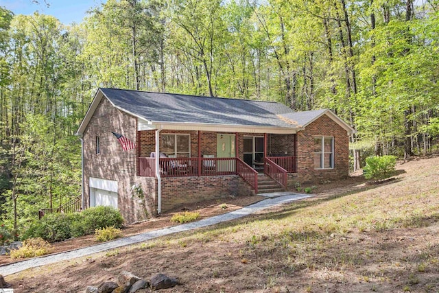 112 Jocassee Falls Rd, Salem, SC 29676 - ranch-style house featuring an attached garage, brick siding, a view of trees, and covered porch