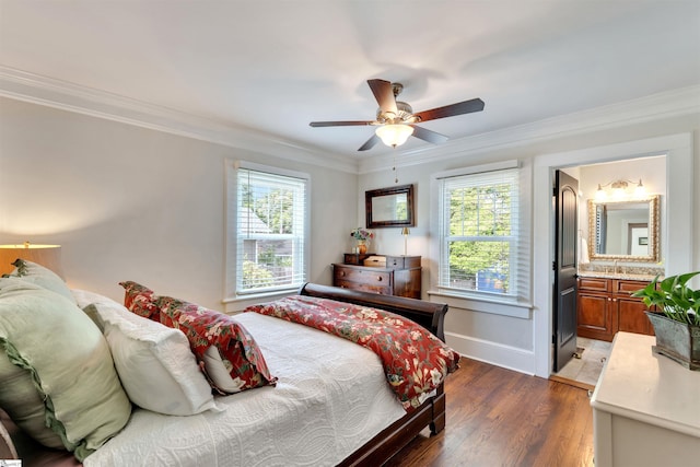 bedroom with a ceiling fan, crown molding, wood finished floors, a sink, and baseboards
