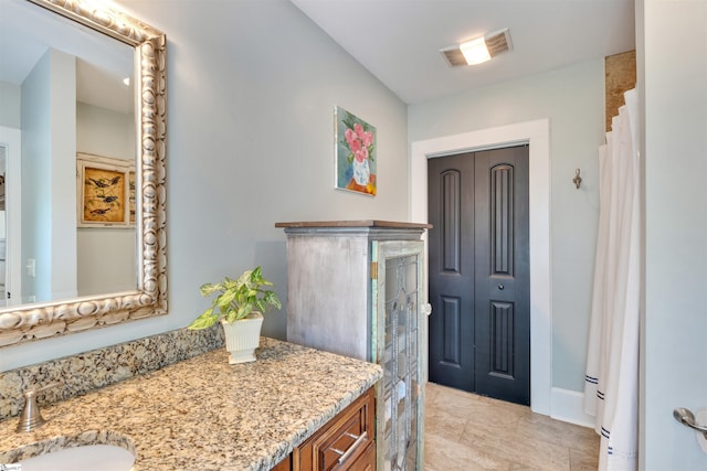 bathroom with curtained shower, baseboards, visible vents, and vanity