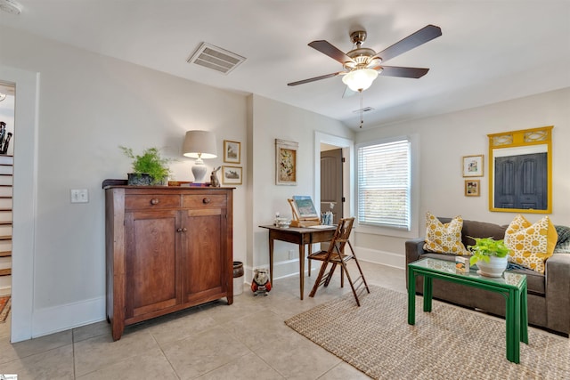 living room with visible vents, baseboards, ceiling fan, and light tile patterned floors