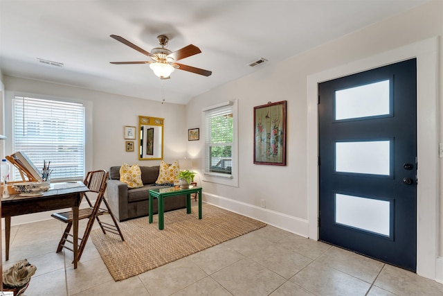 interior space with light tile patterned floors, baseboards, visible vents, and ceiling fan
