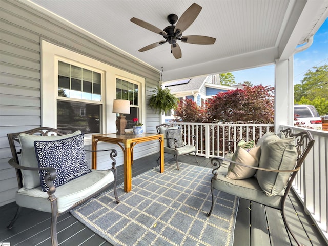 wooden terrace with ceiling fan and covered porch