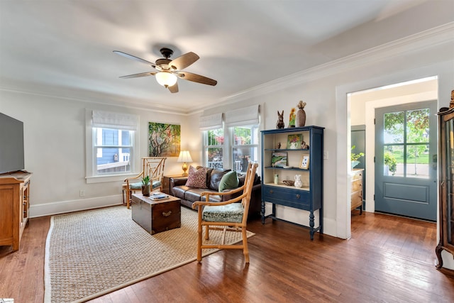 living room with crown molding, a wealth of natural light, a ceiling fan, and hardwood / wood-style flooring