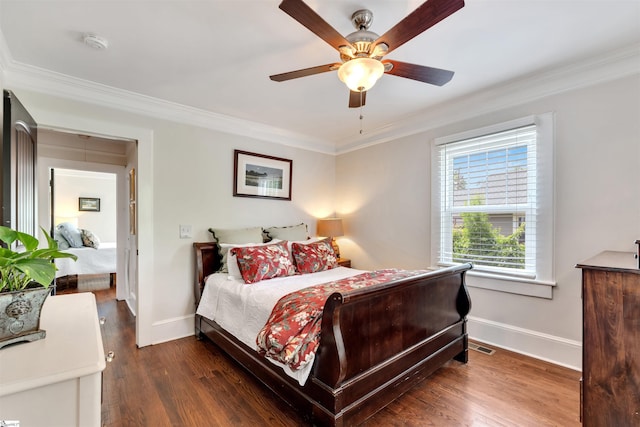 bedroom with baseboards, ornamental molding, wood finished floors, and visible vents