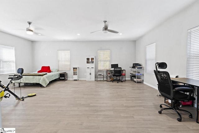 bedroom featuring baseboards, recessed lighting, multiple windows, and light wood-style flooring