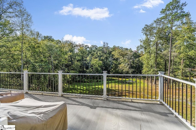 wooden terrace with a yard