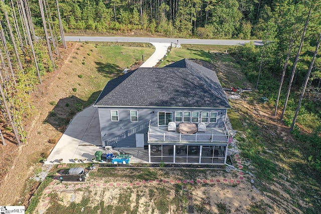 birds eye view of property with a view of trees