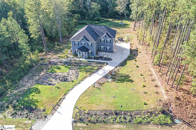 aerial view featuring a wooded view