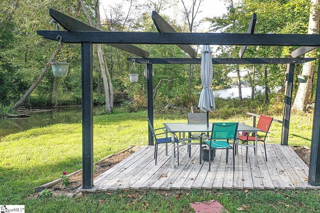 deck featuring a yard, outdoor dining space, and a water view