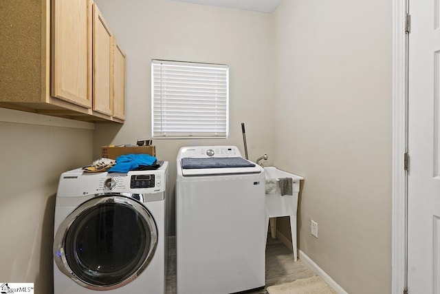 washroom with cabinet space and independent washer and dryer