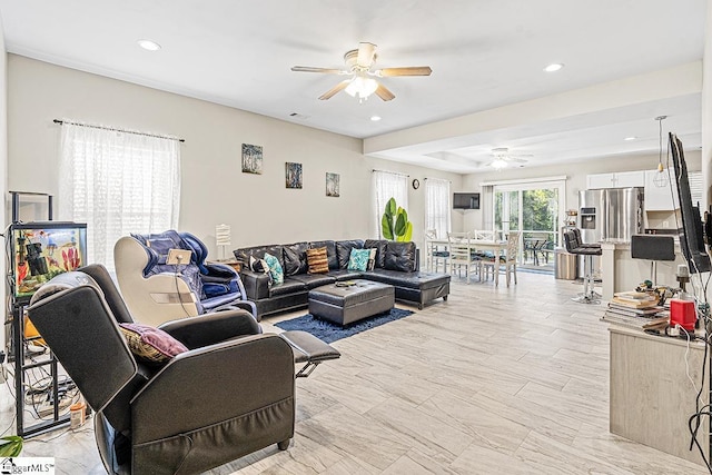 living room featuring a ceiling fan and recessed lighting