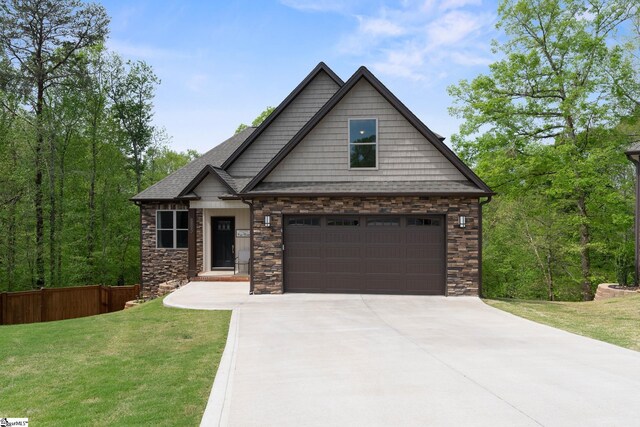 885 Affirmed Dr, Boiling Springs, SC 29316 - craftsman-style house featuring fence, driveway, stone siding, a front yard, and a garage