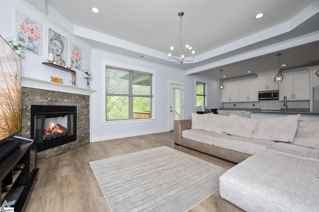 885 Affirmed Dr, Boiling Springs, SC 29316 - living room with a tray ceiling, a fireplace, baseboards, a notable chandelier, and recessed lighting