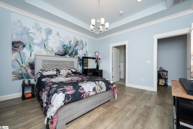 885 Affirmed Dr, Boiling Springs, SC 29316 - bedroom featuring a tray ceiling, baseboards, visible vents, a notable chandelier, and wood finished floors