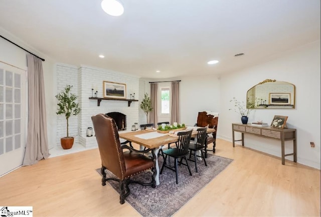 409 Freeman Bridge Rd, Marietta, SC 29661 - dining space featuring light wood finished floors, a fireplace, and recessed lighting