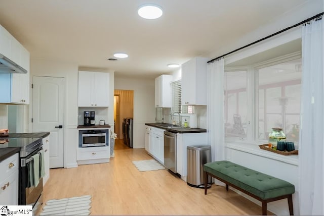 409 Freeman Bridge Rd, Marietta, SC 29661 - kitchen featuring stainless steel appliances, dark countertops, white cabinets, and washing machine and clothes dryer
