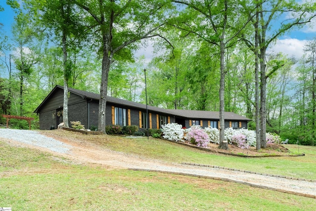 409 Freeman Bridge Rd, Marietta, SC 29661 - mid-century inspired home featuring a front yard, brick siding, and driveway