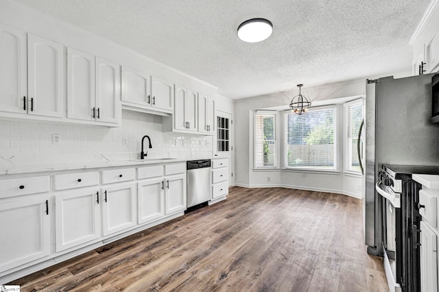 218 Spring View Ln, Taylors, SC 29687 - kitchen with a textured ceiling, a sink, white cabinetry, wood finished floors, and appliances with stainless steel finishes