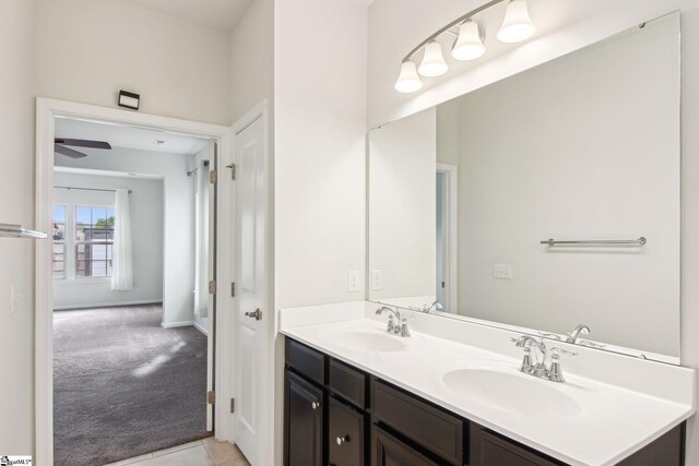 bathroom featuring ceiling fan, tile patterned floors, a sink, and double vanity