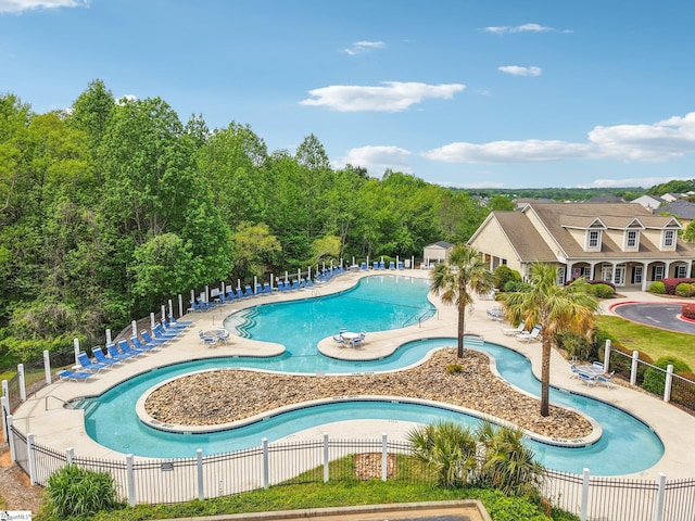 pool with fence and a patio area