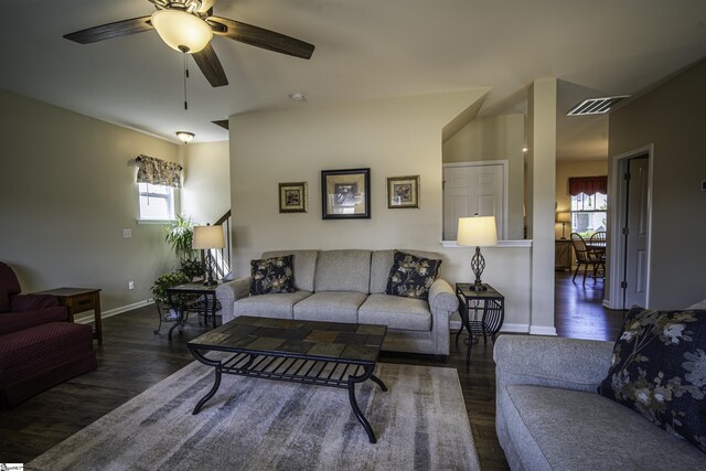 living room featuring baseboards, wood finished floors, visible vents, and a wealth of natural light