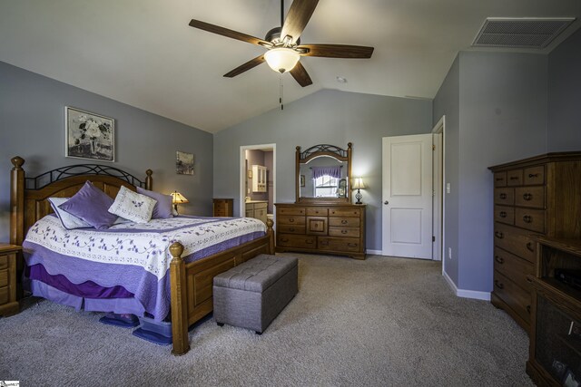 carpeted bedroom with baseboards, visible vents, lofted ceiling, a ceiling fan, and ensuite bath