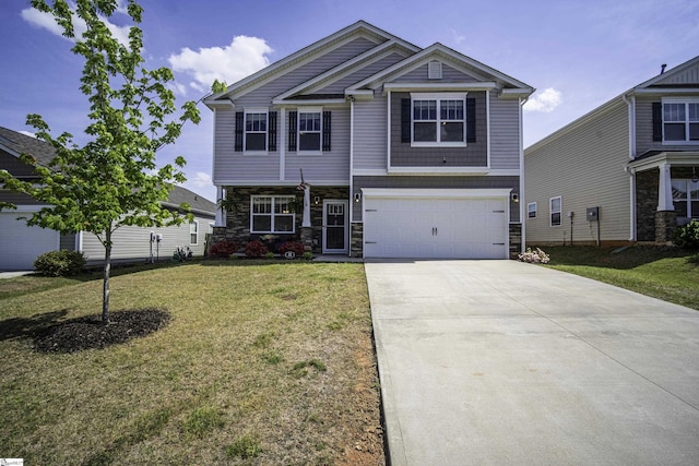 craftsman-style home with a front lawn, driveway, stone siding, and a garage