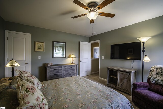 bedroom with carpet floors, a ceiling fan, and baseboards
