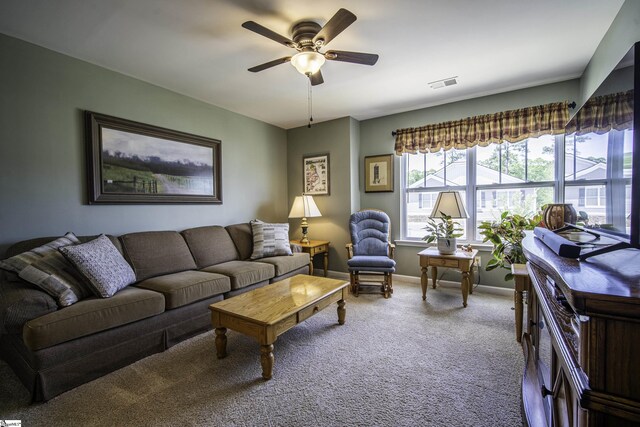 carpeted living room with baseboards, a ceiling fan, and visible vents