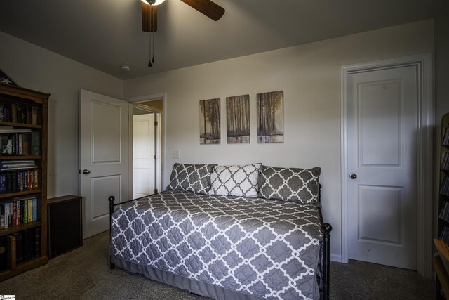 bedroom with a ceiling fan and dark colored carpet