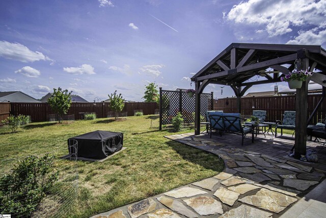 view of yard with a patio area, a fenced backyard, and a gazebo