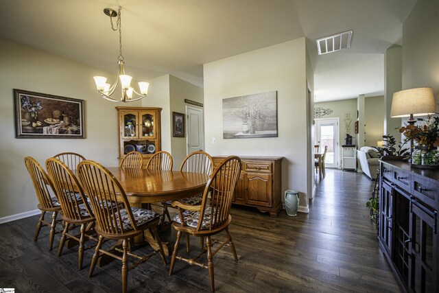 dining area featuring baseboards, dark wood-style flooring, a chandelier, and visible vents
