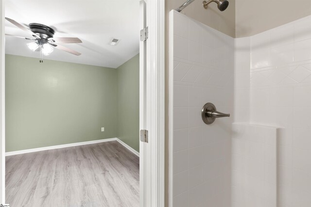 381 Deer Farm Pond Ln, Fair Play, SC 29643 - full bathroom with baseboards, a ceiling fan, wood finished floors, and tiled shower