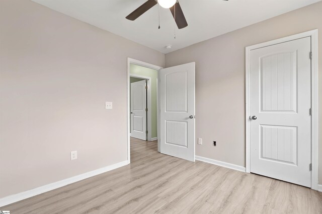 381 Deer Farm Pond Ln, Fair Play, SC 29643 - unfurnished bedroom with light wood-style flooring, baseboards, and a ceiling fan