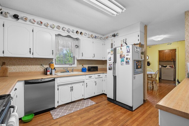 222 Mason Dr, Inman, SC 29349 - kitchen with stove, washer and clothes dryer, dishwasher, a sink, and freestanding refrigerator