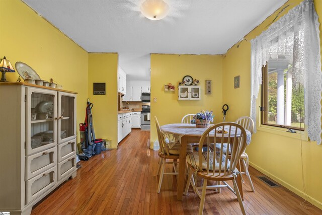 222 Mason Dr, Inman, SC 29349 - dining room featuring wood-type flooring, visible vents, and baseboards