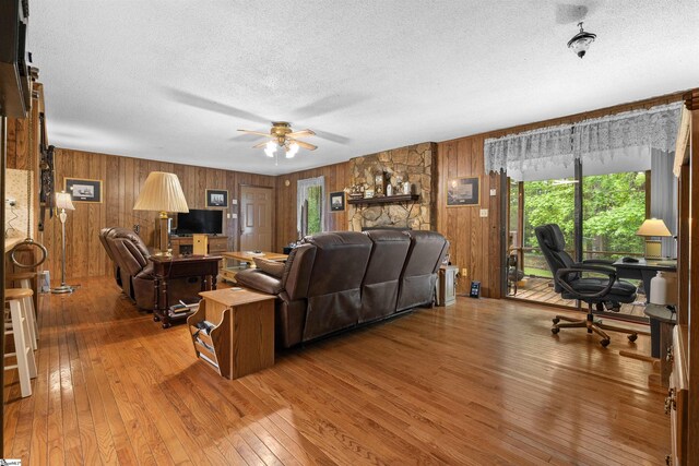222 Mason Dr, Inman, SC 29349 - living area featuring hardwood / wood-style floors, a textured ceiling, wood walls, and a ceiling fan
