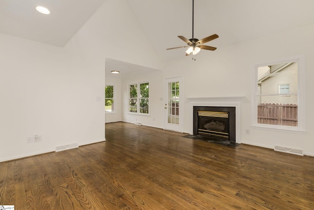 unfurnished living room featuring a fireplace with flush hearth, wood finished floors, visible vents, and ceiling fan