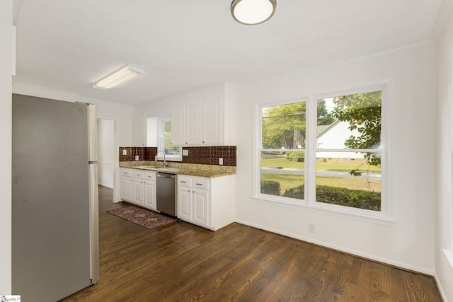 kitchen featuring appliances with stainless steel finishes, dark wood-type flooring, white cabinetry, and plenty of natural light