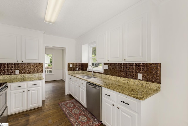 kitchen with white cabinets, dark wood finished floors, backsplash, a sink, and appliances with stainless steel finishes