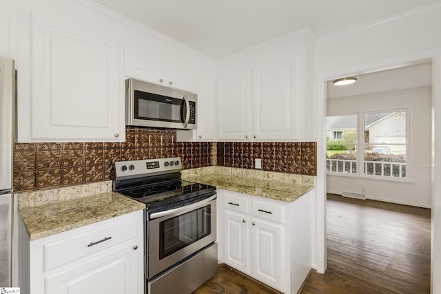 kitchen featuring backsplash, appliances with stainless steel finishes, crown molding, and white cabinetry