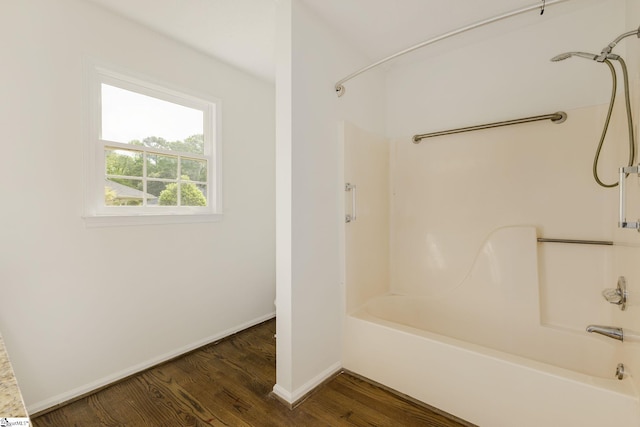full bathroom featuring baseboards, shower / bathtub combination, and wood finished floors