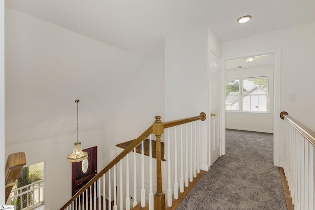 hallway featuring carpet and an upstairs landing