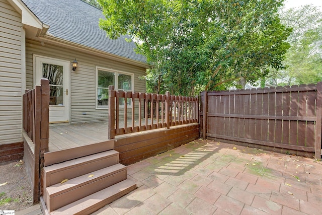 wooden terrace featuring fence and a patio area
